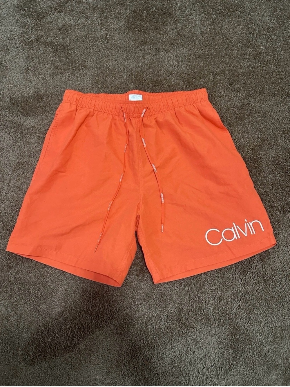 Calvin Klein Men’s Bright Orange Swim Trunks with White Logo